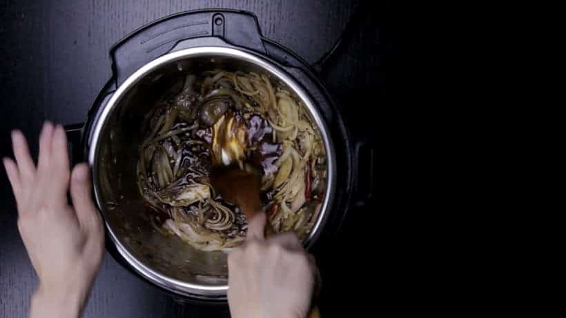 deglaze bottom of inner pot liner with wooden spoon