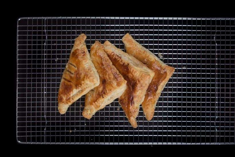 Easy Apple Turnovers Recipe - make these with only 4 ingredientsEasy Apple Turnovers Recipe (Only 4 Ingredients & 10-mins prep)! Flaky & crisp buttery puff pastry, bursting with warm cinnamon-spiced applesauce. Perfect Autumn desserts.