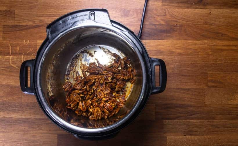 stir candied pecans until maple sriracha sauce darkens