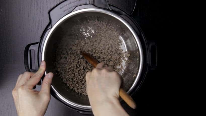 Make Family Favorite Instant Pot Sloppy Joes Recipe (Pressure Cooker Sloppy Joes): loosen up the ground beef into crumble bits with a wooden spoon for browning process