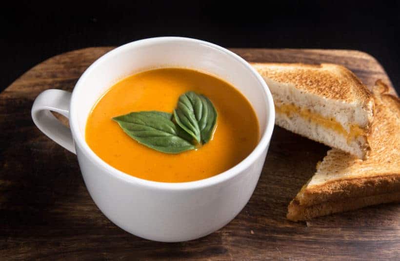 Make this Delicious Creamy Comfort: Instant Pot Tomato Soup Recipe (Pressure Cooker Tomato Soup)! This homemade tomato basil soup from scratch (with vegan option) is healthy, super easy to make, and freezer-friendly. Perfect dip for the toasted golden grilled cheese.